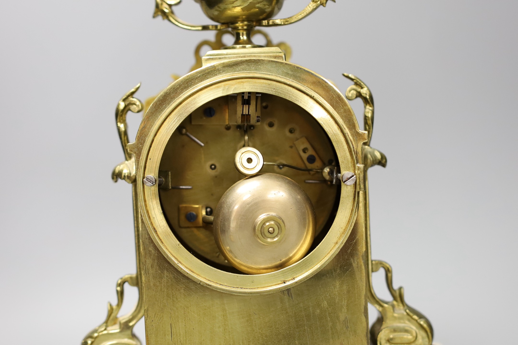 A 19th century French brass and alabaster mantel clock and a pair of dragon candlesticks, clock 28cms high
